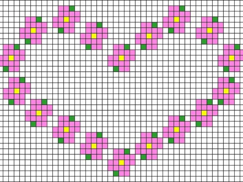 Gráfico de ponto cruz mostrando um coração formado por flores rosa com centros amarelos e folhas verdes.